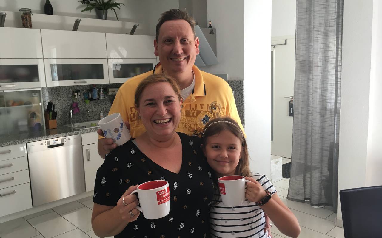 Frau, Mann und Kind mit Radio Essen-Tassen.