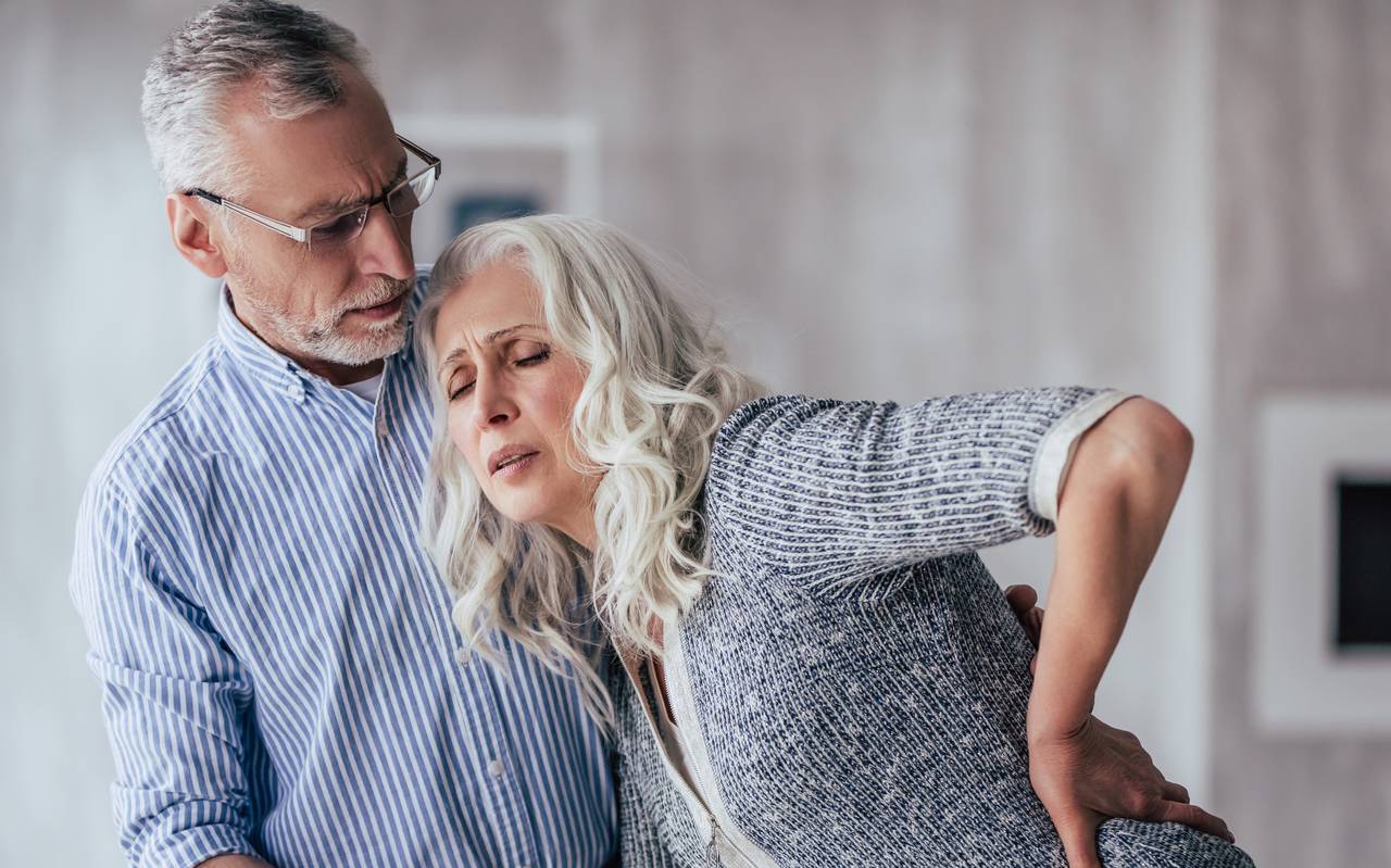 Doctor vaccinating a senior woman.