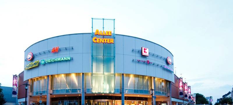 Ein großes rundes Shoppingcenter im Stadtteil Altenessen mit viel Leucht-Reclame der Geschäfte.