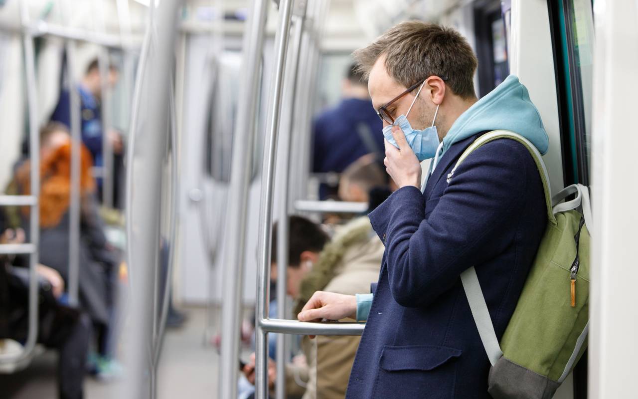 Ein kranker Mann fühlt sich schlecht – er trägt eine Atemschutzmaske gegen Infektionen.