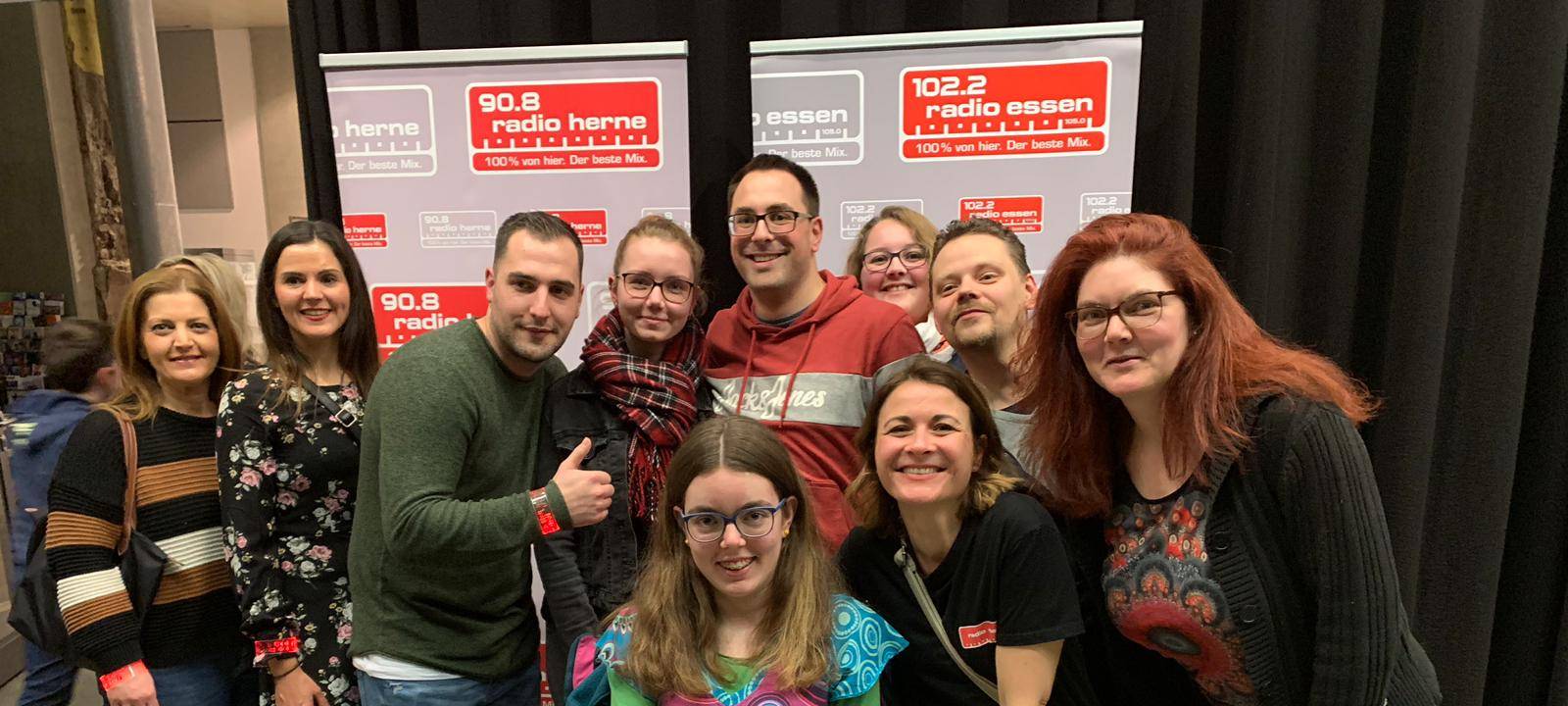 Viele Personen lächeln in die Kamera