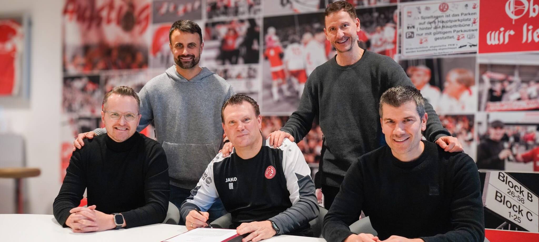 RWE-Chefcoach Uwe Koschinat (Mitte, vorne) bei der Vertragsverlängerung an der Hafenstraße mit (von links) Sportdirektor Christian Flüthmann, Vorstand Alexander Rang, Vorstandsvorsitzender Marc-Nicolai Pfeifer und Direktor Profifußball Marcus Steegmann.